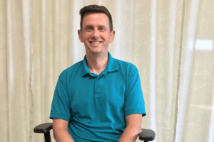 Nick Sobieraj , our speech and language therapist at Nottingham Brain Injury Rehabilitation Centre, smiling at the camera.