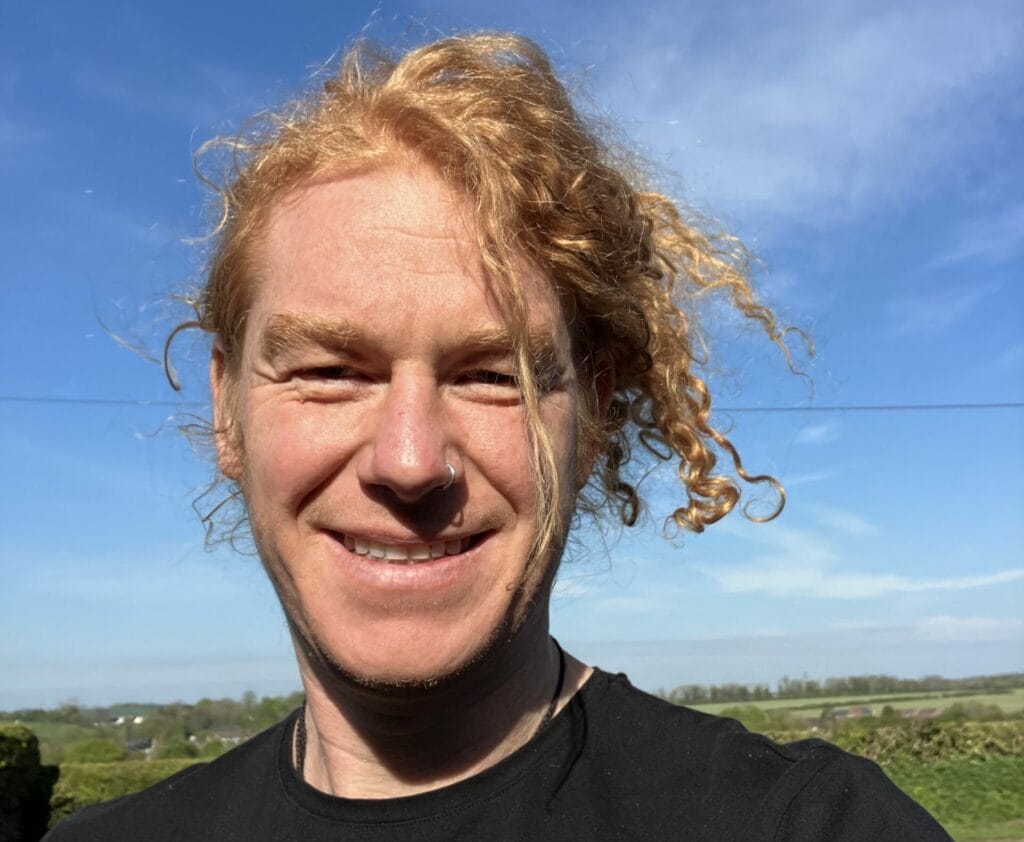 David smiling at the camera in the sunshine.