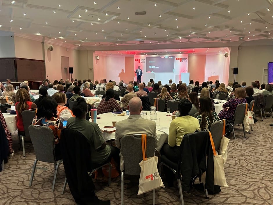 A wide shot of people at the conference.